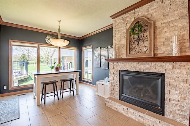 dining area featuring baseboards, ornamental molding, and visible vents