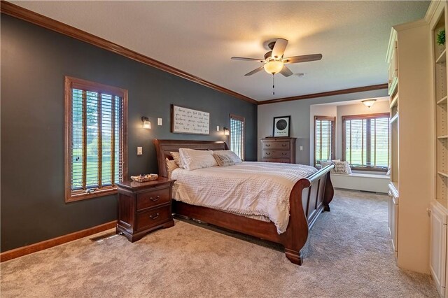 bedroom with baseboards, ornamental molding, ceiling fan, and carpet floors
