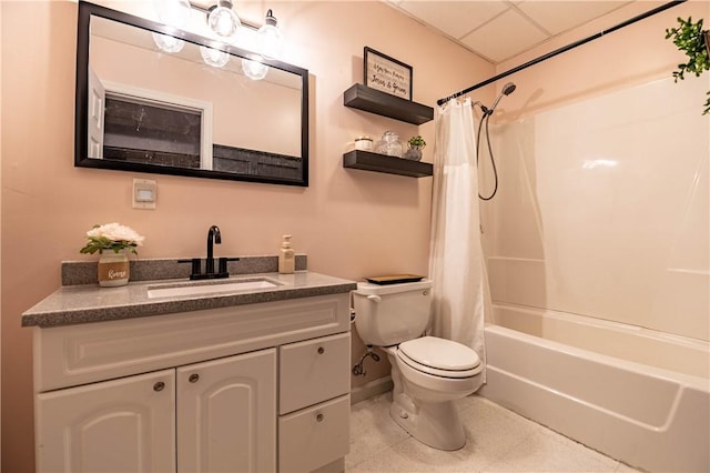 full bath with a paneled ceiling, toilet, baseboards, shower / bathtub combination with curtain, and vanity