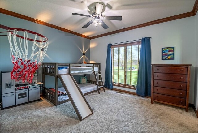 carpeted bedroom featuring visible vents, ceiling fan, and ornamental molding