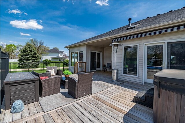 wooden terrace with an outdoor living space and fence