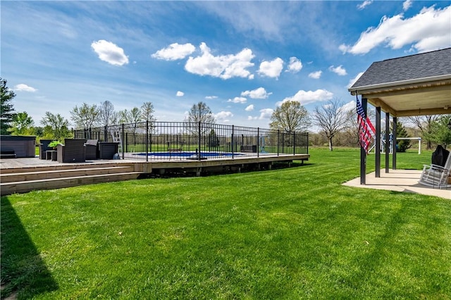 surrounding community with a wooden deck, a yard, a patio area, and fence