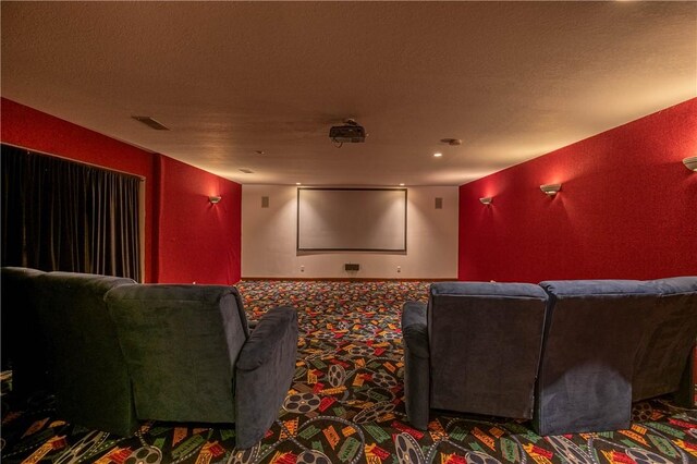 cinema room with recessed lighting, a textured ceiling, and carpet