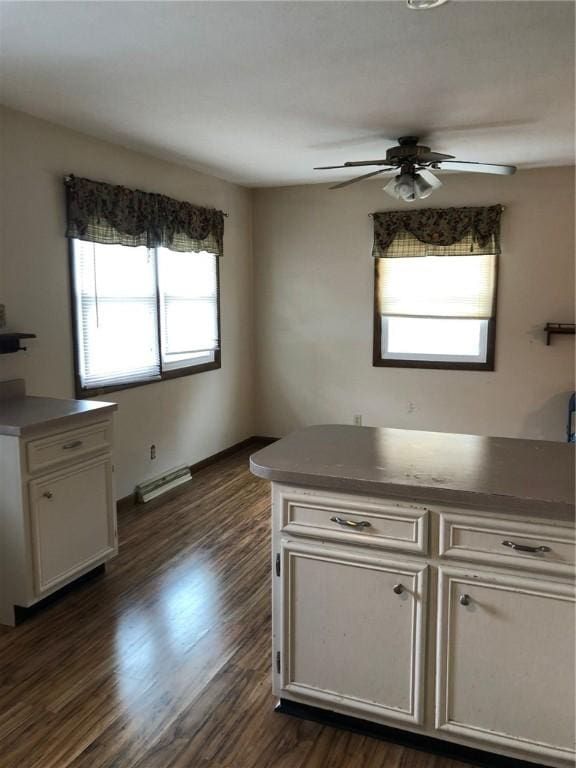 kitchen with ceiling fan, dark wood-style flooring, and white cabinets