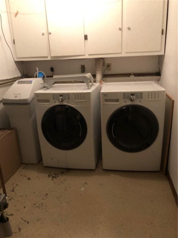 laundry area with cabinet space and washing machine and clothes dryer