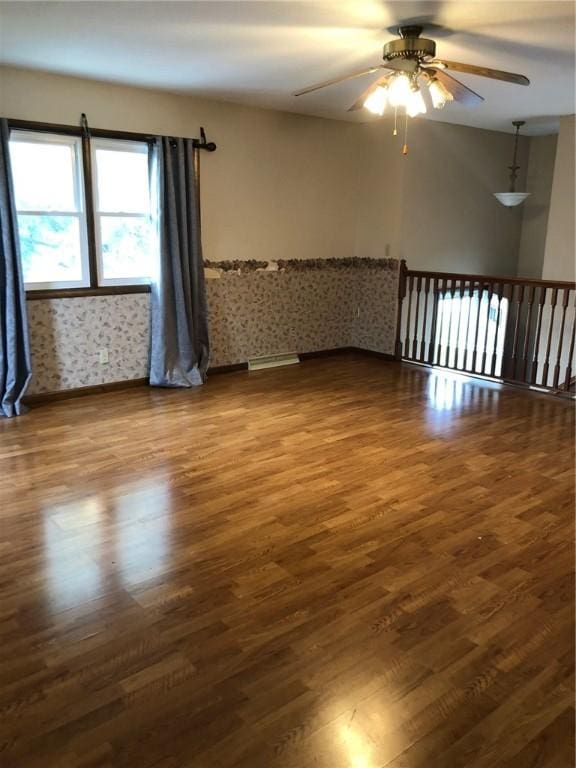 unfurnished room with ceiling fan and wood finished floors