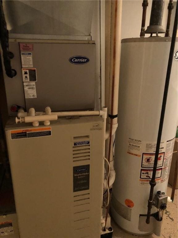 utility room with water heater and heating unit