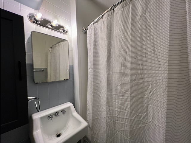 bathroom with tile walls and sink