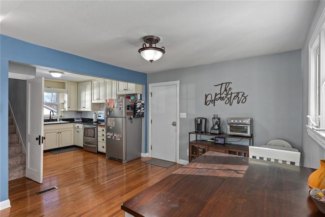 dining room featuring sink and light hardwood / wood-style flooring