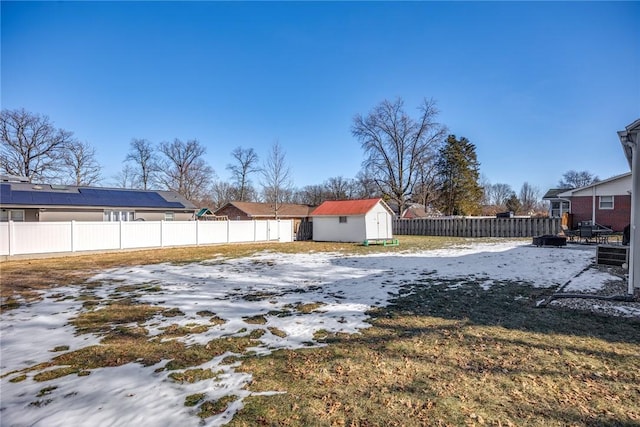 yard covered in snow with a shed