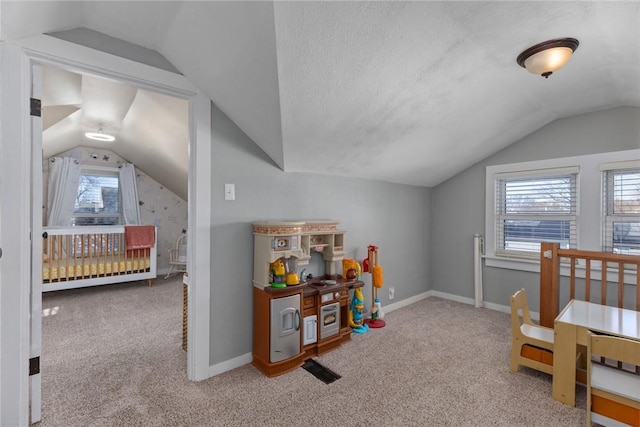 carpeted bedroom with lofted ceiling and a textured ceiling