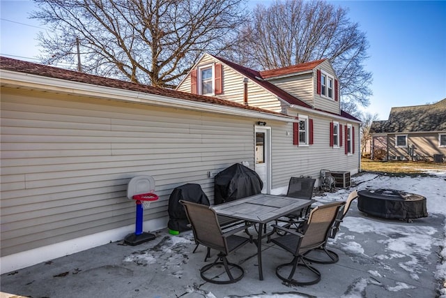 view of patio featuring a grill, central AC, and an outdoor fire pit