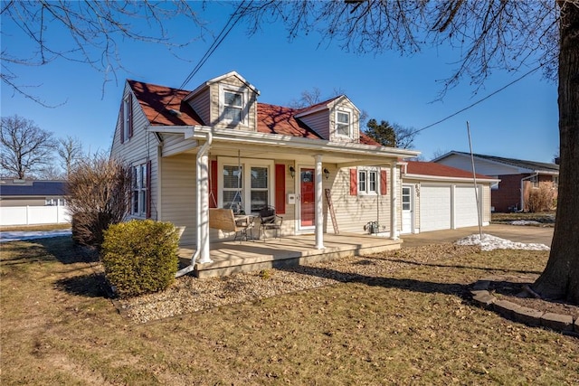 cape cod home with a garage and covered porch