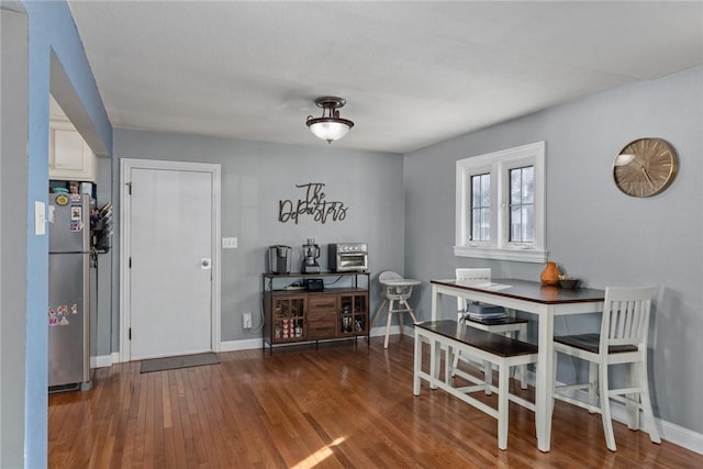 dining space featuring dark wood-type flooring