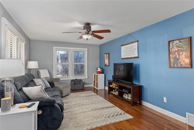 living room with ceiling fan and dark hardwood / wood-style flooring