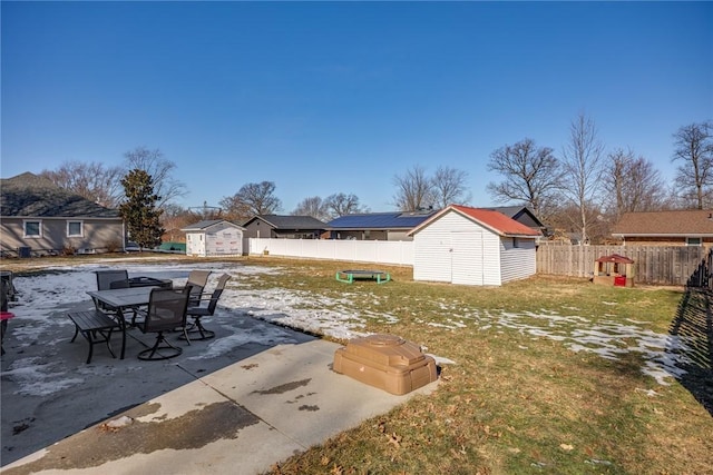 view of yard with a storage shed and a patio