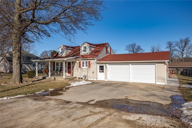 new england style home featuring a porch and a garage