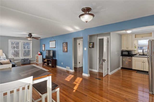 interior space featuring hardwood / wood-style flooring, ceiling fan, and sink