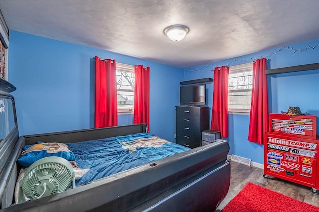 bedroom with dark wood-type flooring