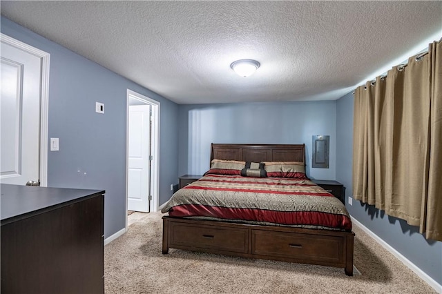 bedroom featuring light colored carpet and a textured ceiling