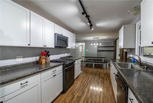 kitchen featuring white cabinetry, sink, and black appliances