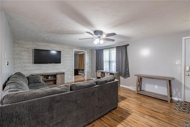 living room featuring hardwood / wood-style flooring and ceiling fan