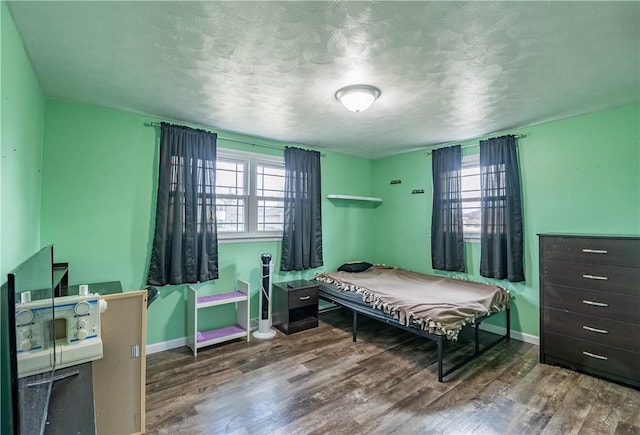 bedroom featuring hardwood / wood-style floors and a textured ceiling