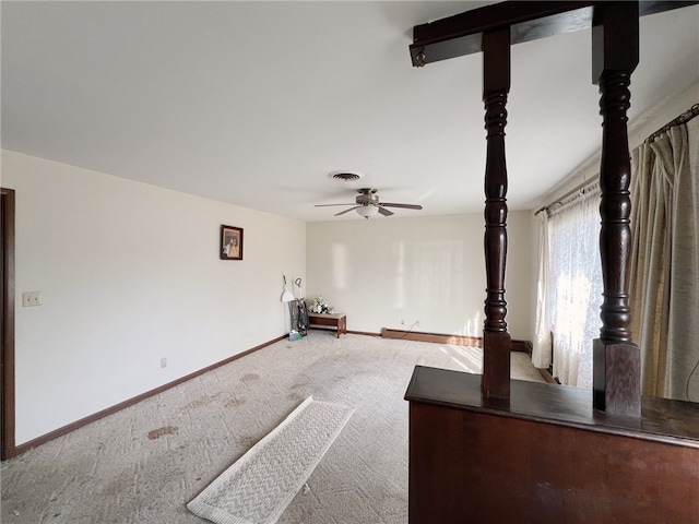 interior space with ceiling fan and light colored carpet