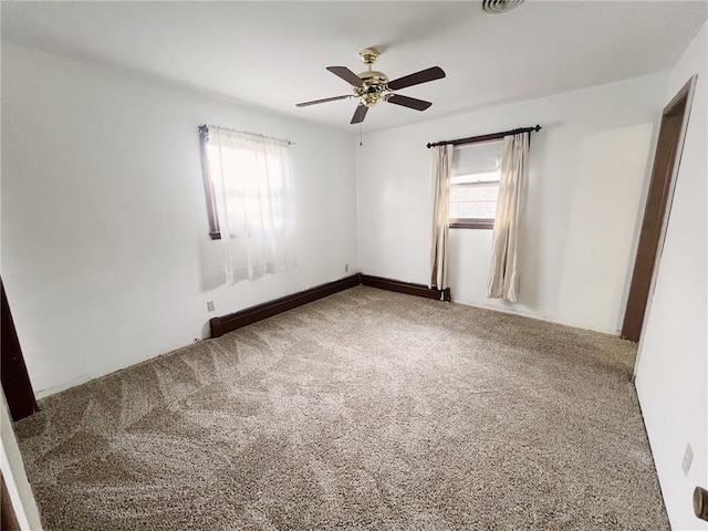 2810 Townway Rd, Danville, IL 61832 - carpeted empty room with plenty of natural light, a baseboard heating unit, and ceiling fan