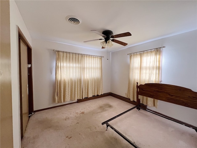 interior space featuring ceiling fan and light carpet