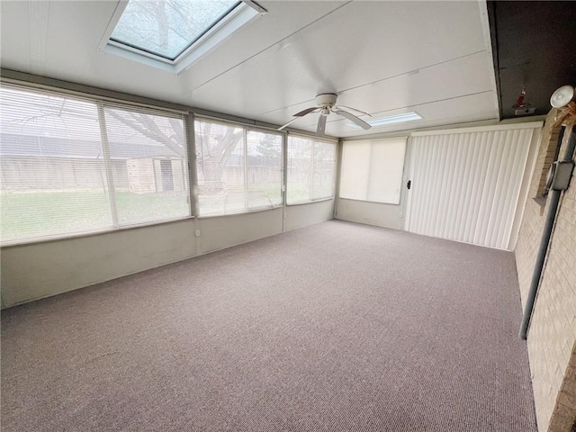 2810 Townway Rd, Danville, IL 61832 - unfurnished sunroom featuring carpet flooring, a ceiling fan, and a skylight