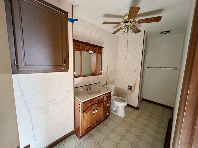 bathroom featuring vanity, ceiling fan, and toilet