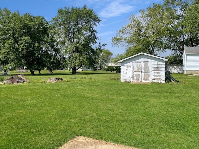 6 S Oakland Rd, Ashmore, IL 61912 - view of green lawn with a storage shed and an outbuilding