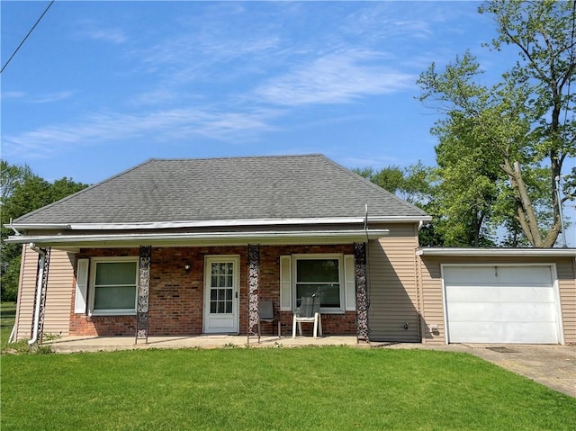 6 S Oakland Rd, Ashmore, IL 61912 - view of front of house featuring a porch, a front yard, brick siding, and an attached garage