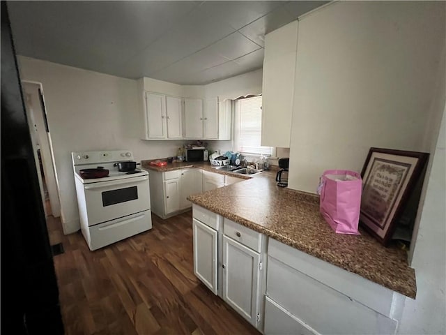 kitchen featuring white cabinets, white range with electric stovetop, a sink, stainless steel microwave, and dark wood-style floors