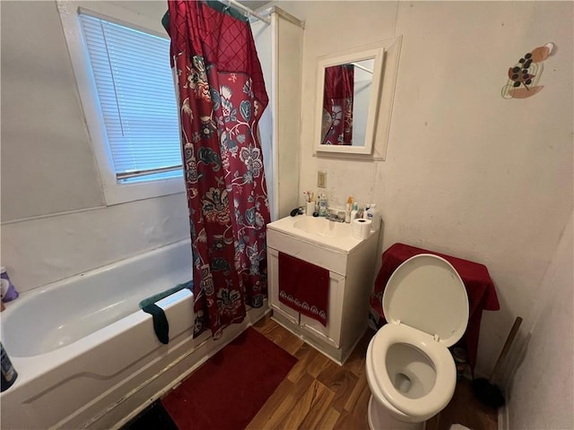 full bathroom featuring vanity, shower / bath combo, toilet, and wood finished floors