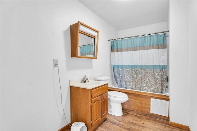 full bathroom featuring toilet, shower / tub combo, vanity, and hardwood / wood-style floors