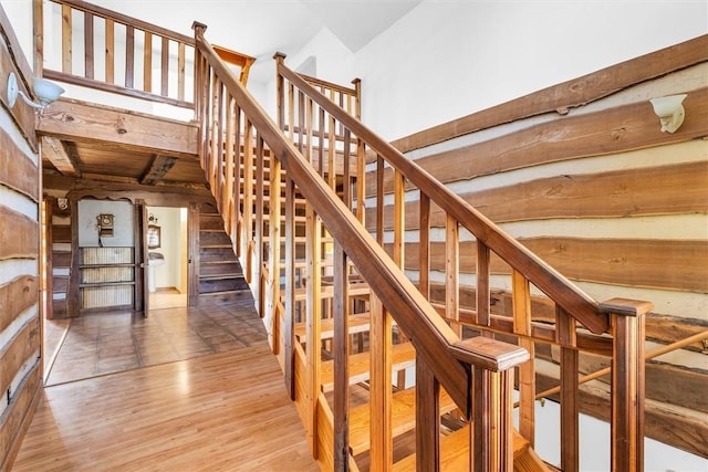 stairway with wood ceiling, hardwood / wood-style floors, and vaulted ceiling