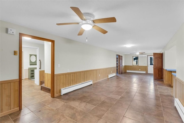 empty room with a baseboard heating unit and ceiling fan