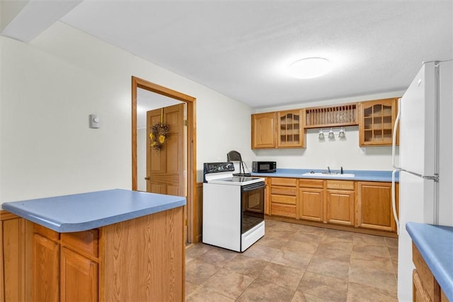 kitchen featuring white appliances and sink