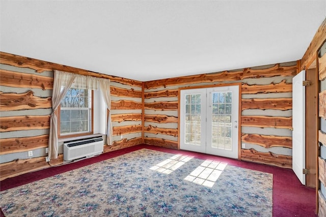 unfurnished living room with a wall mounted air conditioner, log walls, and dark carpet