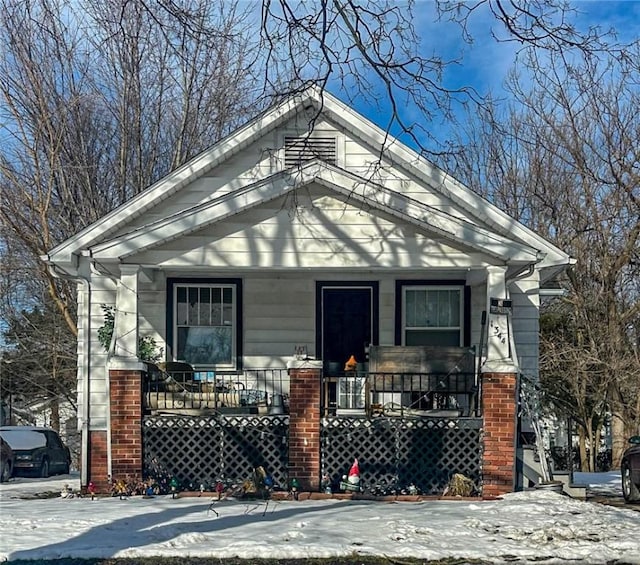 view of snow covered exterior with a porch