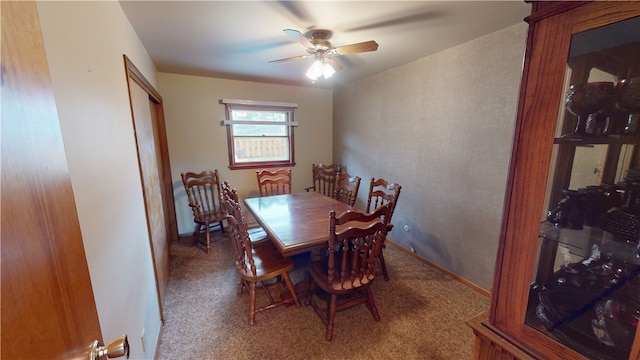 carpeted dining room featuring ceiling fan