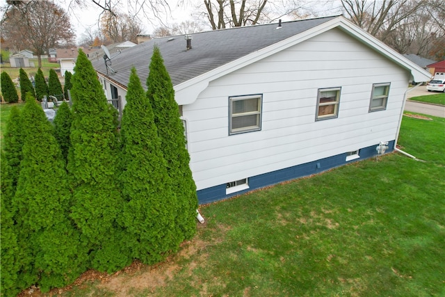 view of property exterior with a yard