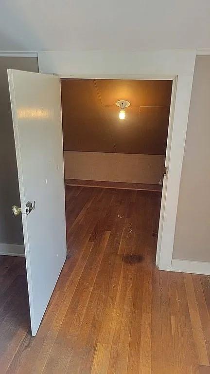 203 N E St, Olney, IL 62450 - unfurnished room featuring wood finished floors and baseboards