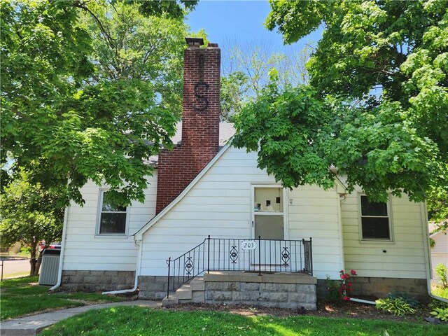 203 N E St, Olney, IL 62450 - back of house with a chimney