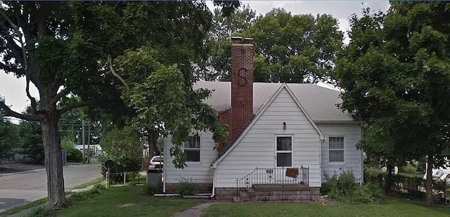 203 N E St, Olney, IL 62450 - back of property featuring a chimney and a lawn