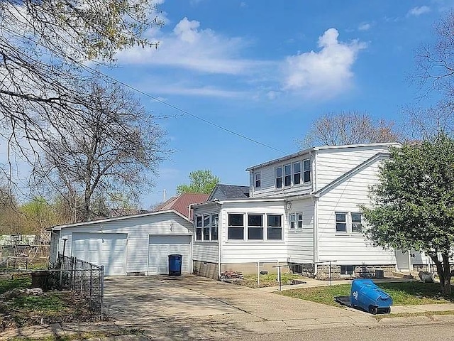 203 N E St, Olney, IL 62450 - back of house with an outdoor structure and a garage