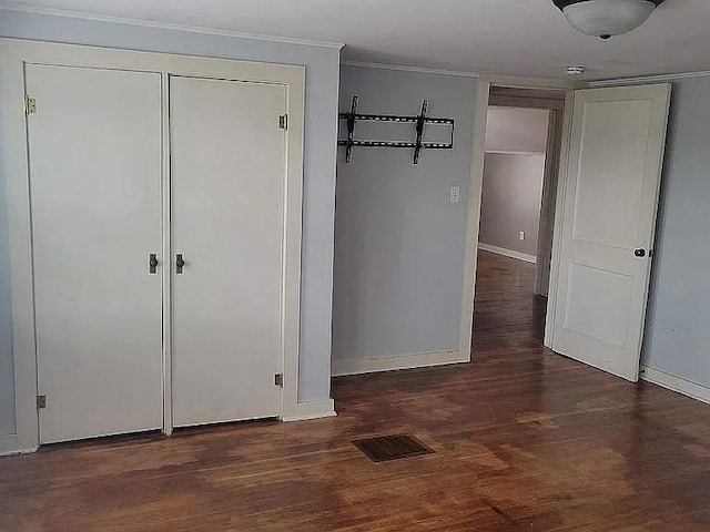 203 N E St, Olney, IL 62450 - unfurnished bedroom with baseboards, wood finished floors, and ornamental molding