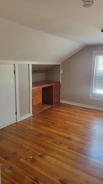 203 N E St, Olney, IL 62450 - additional living space featuring lofted ceiling, dark wood finished floors, and baseboards